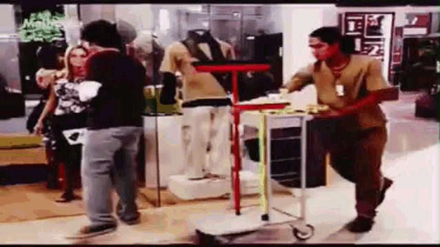 a man is pushing a cart in a store while a woman stands behind him