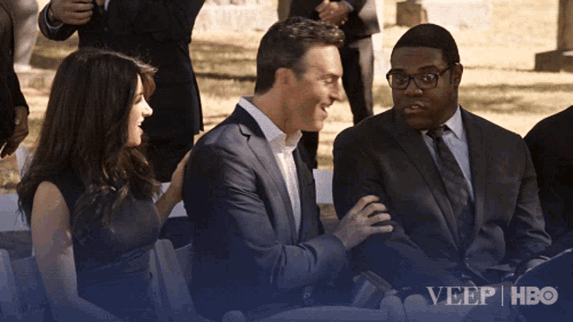a group of people sitting in front of a sign that says ' veep hbo ' on it
