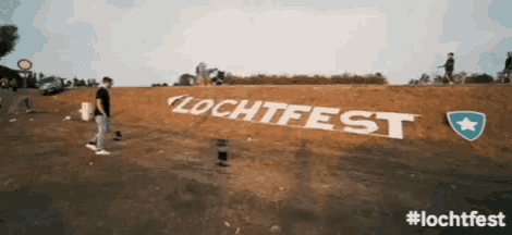 a man stands in front of a large sign that says ' lechtfest ' on it