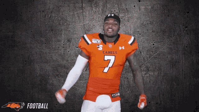 a football player wearing an orange jersey with the number 7