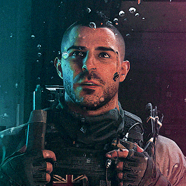 a man with a mohawk is holding a gun with a british flag on it