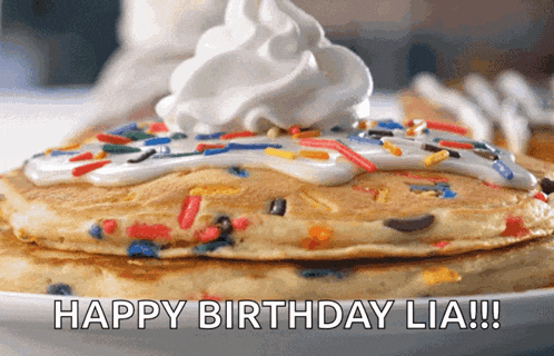 a birthday pancake with whipped cream and sprinkles on top
