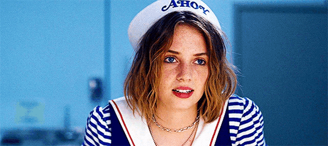 a woman wearing a sailor hat that says ahoy on it