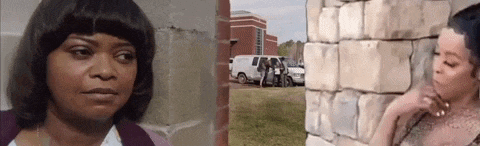a woman standing next to a brick wall and a woman standing next to a van .