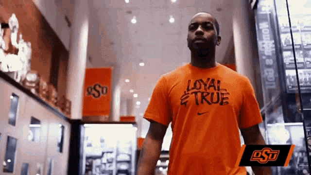 a man in an orange shirt that says loyal and true