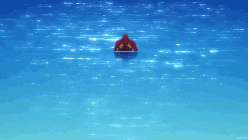 a man in a blue shirt stands next to a woman holding a mop on a beach