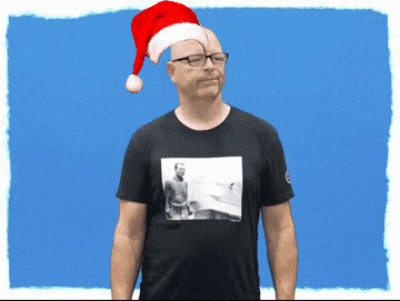 a man wearing glasses and a santa hat
