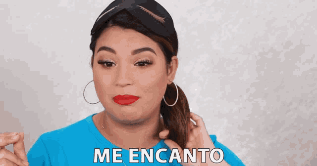 a woman in a blue shirt says me encanto in spanish