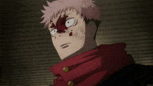 a close up of a person 's face with blood on it and a red scarf around their neck .