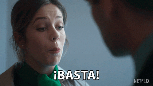 a woman with a green scarf says basta