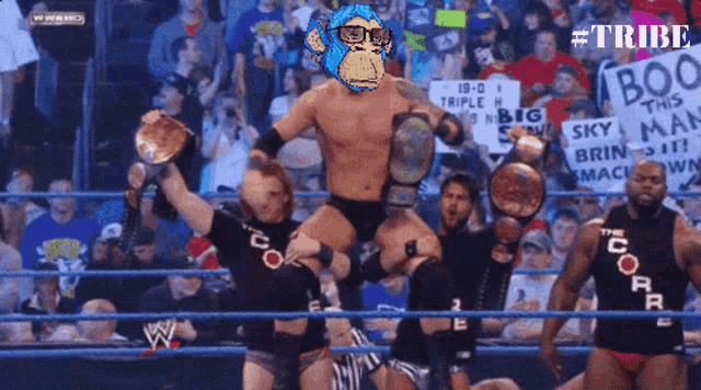 a group of wrestlers are in a ring with a sign that says boo this man