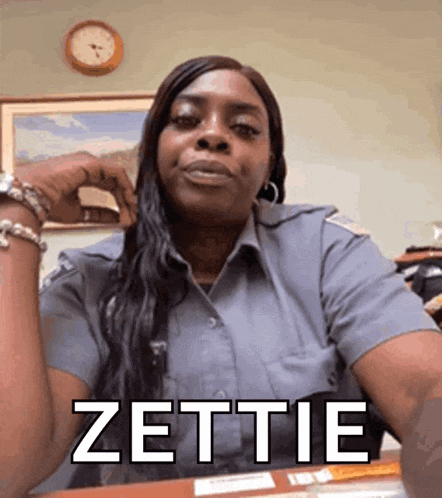 a woman in a police uniform is sitting at a desk with the word zottie written on her face