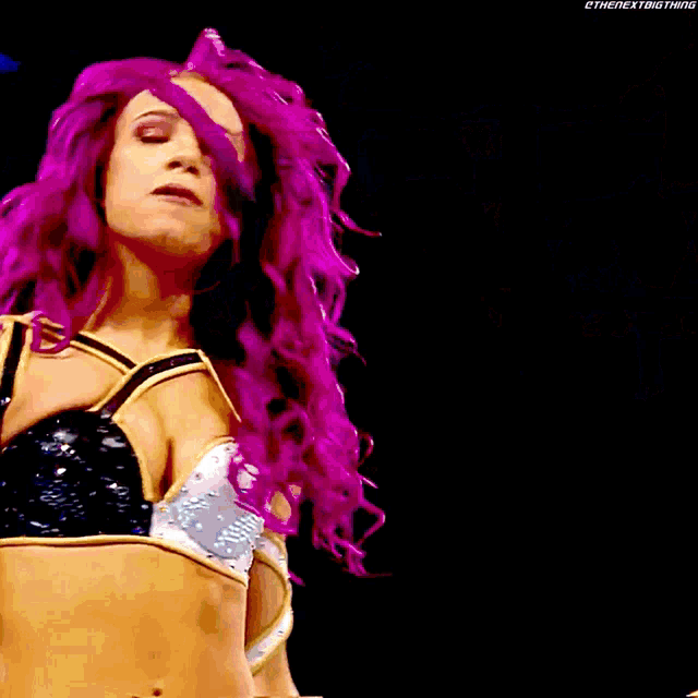 a woman with purple hair stands next to another woman with blonde hair