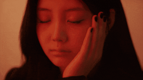 a close up of a woman 's face with her eyes closed