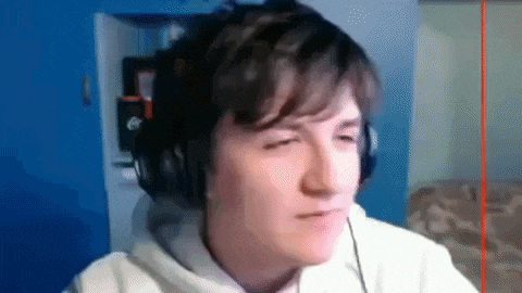 a young man wearing headphones is looking at the camera