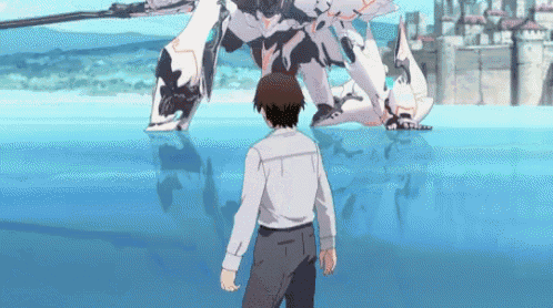 a man in a white shirt stands in front of a robot