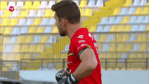 a soccer player wearing a red jersey that says kansas on it