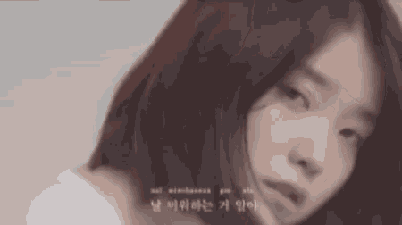 a close up of a woman 's face with foreign writing on the bottom