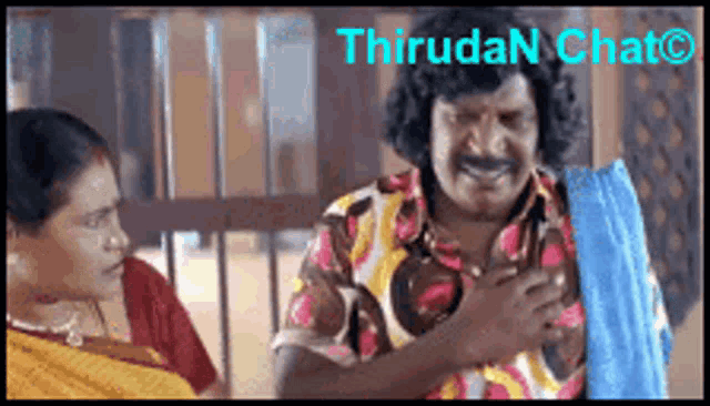 a man in a colorful shirt is smiling while talking to a woman in a yellow shirt ..