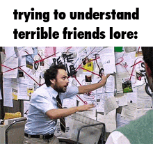a man is pointing at a bulletin board that says ' trying to understand terrible friends lore ' on it