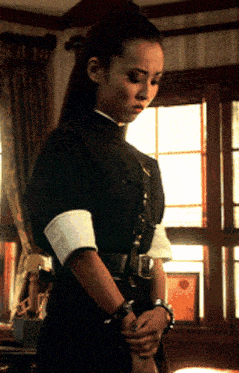 a woman standing in front of a window wearing a black and white outfit
