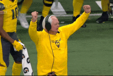 a man wearing headphones and a yellow shirt that says espn