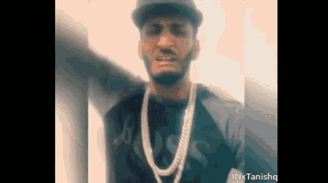 a man with a beard wearing a hat and a necklace with the word boss on it