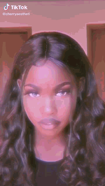 a close up of a woman 's face with long hair and a wig .