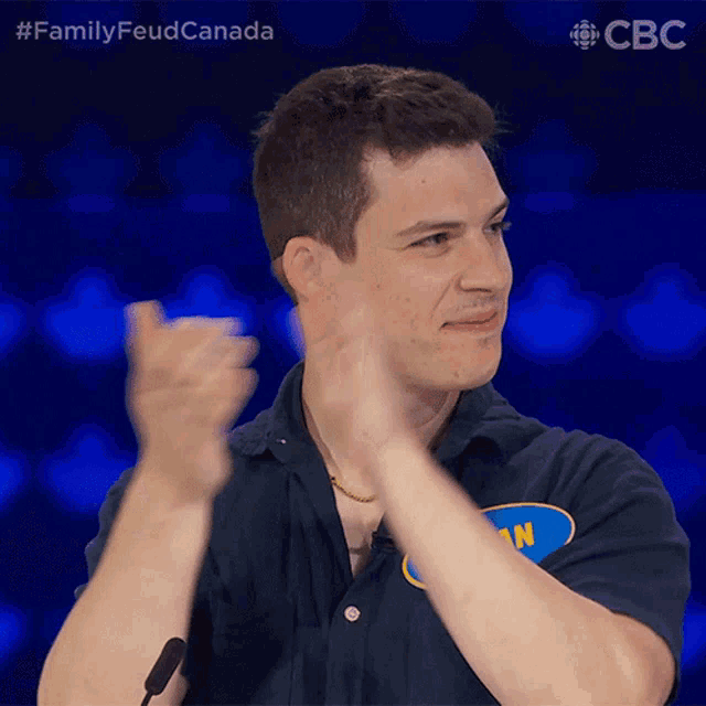 a man applauds while wearing a shirt that says ian