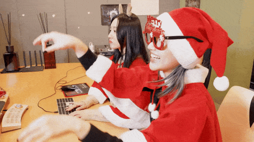 a woman wearing a santa hat with the word hello written on it