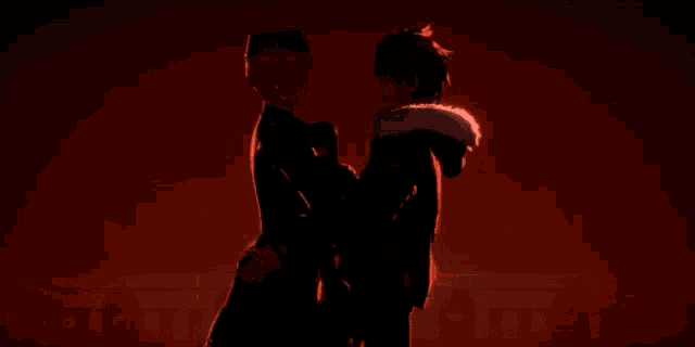 a couple of anime characters standing next to each other in front of a red background