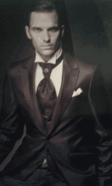 a man in a tuxedo with a black tie