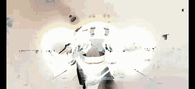a person playing drums with a skull with a cross on it