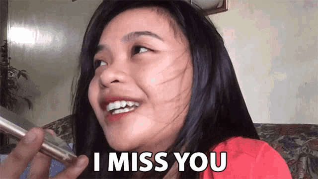 a woman says i miss you while smiling