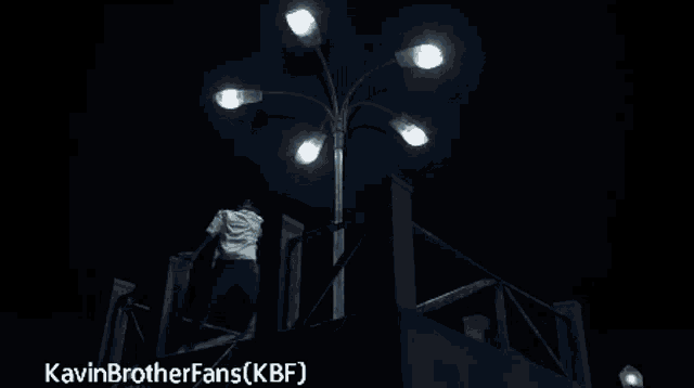a man dancing on a balcony with the words kavinbrotherfans ( kbf ) written on the bottom