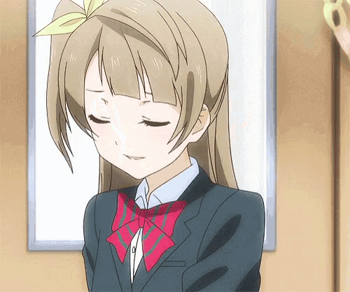 a girl with a bow in her hair is wearing a suit