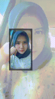 a woman wearing a hijab is taking a picture of herself in a car