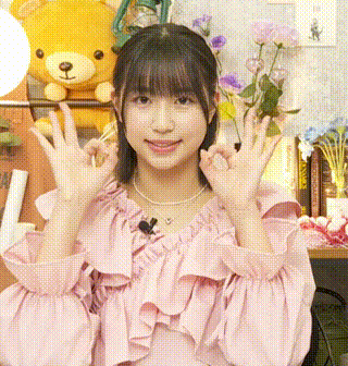 a girl in a pink ruffled top is making a peace sign