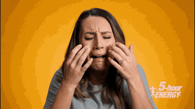 a woman covering her face with her hands with the words 5 hour energy written on the bottom