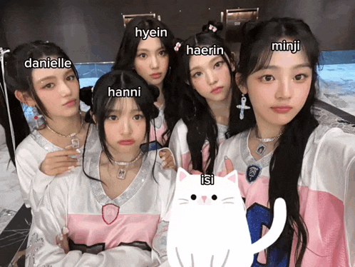 a group of girls are posing for a picture and one of them has the name danielle written on her forehead