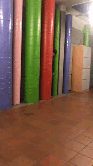 a row of colorful pipes in a hallway