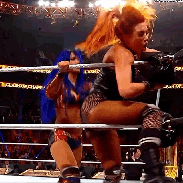 two women in a wrestling ring with clash of champions written on the side