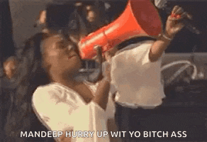 a man is holding a megaphone over a woman 's face .