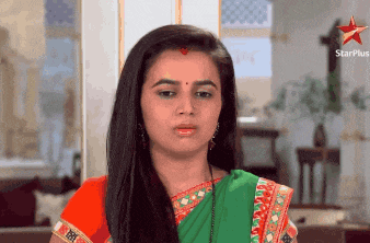 a woman in a green and red saree with a star plus logo on the bottom right