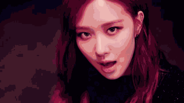 a close up of a woman with red hair making a funny face and looking at the camera .