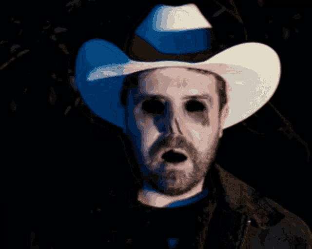 a man in a cowboy hat with black eyes