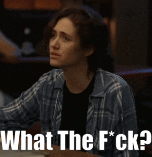 a woman in a plaid shirt is sitting at a table with the words what the f * ck written below her