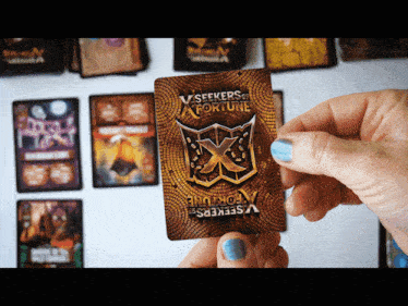 a person holding a card that says vseekers of fortune