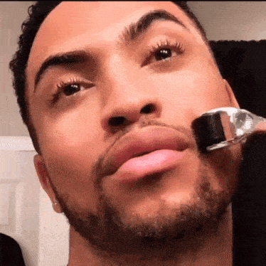 a man is using a roller on his face