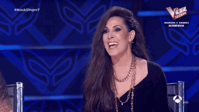 a woman in a black dress is on a tv show called masksinger7